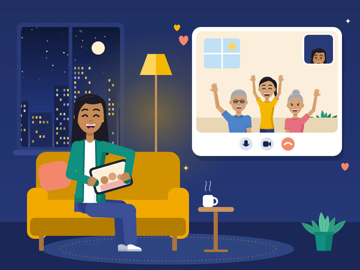 A nurse relaxes on her sofa in her flat abroad in the evening and smiles at her family waving on a video call.