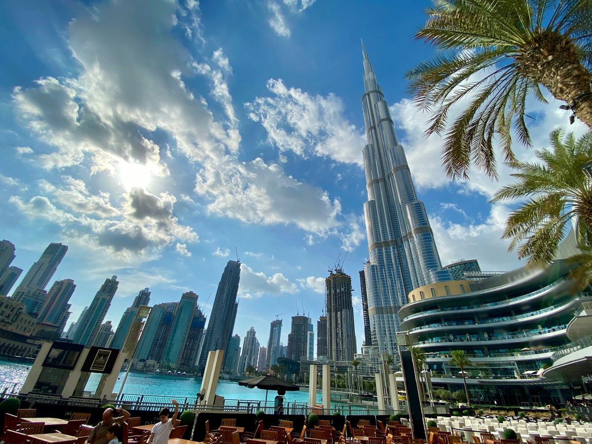 Downtown Dubai's towers and palm trees under a bright sky